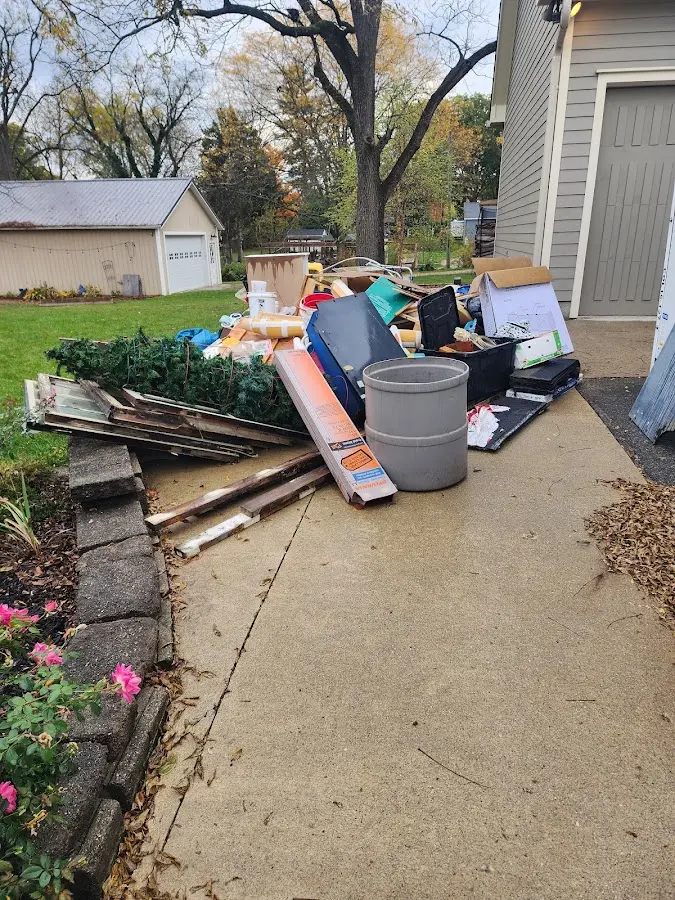 Dumpster being loaded with debris for Estate Cleanout Dumpster Rental in Stuttgart